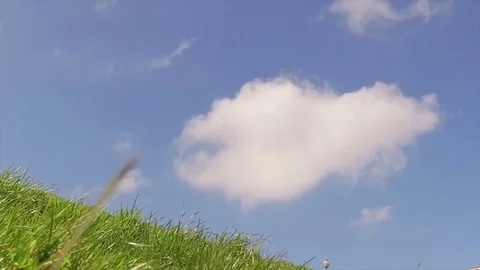 Blue sky with white clouds and hill with green grass Stock Footage 73953631