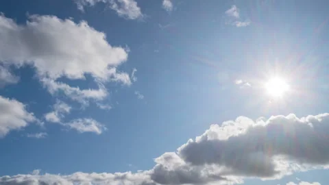 Blue sky with white clouds and sun. Puffy fluffy white clouds. Stock Footage 253214444