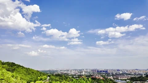 Blue Sky, White Clouds and Distant Bustling City Stock Footage 318542485