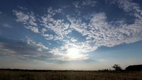 Blue Sky with White Clouds and Sun. Puffy Fluffy White Clouds Moving Fast. .. Stock Footage 345083338
