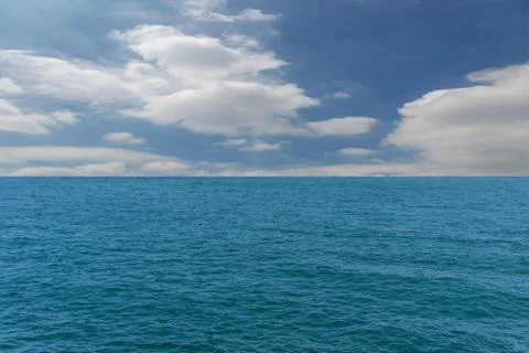 Blue sky, white clouds and the sea Stock Photos