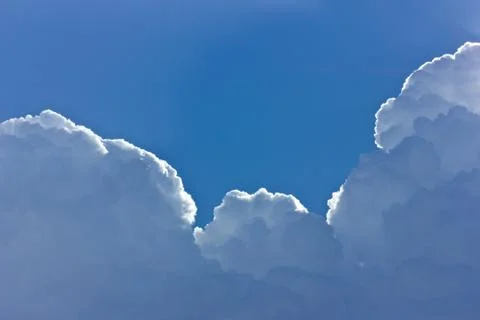 Blue sky with white clouds and sun rays Stock Photos