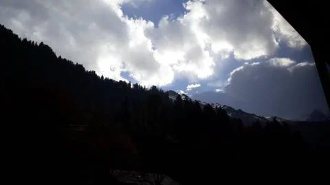 Blue sky, white clouds and silhouettes of mountains. Stock Photos