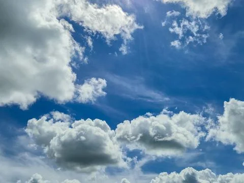 Blue Sky With White Clouds and Sunlight Stock Photos