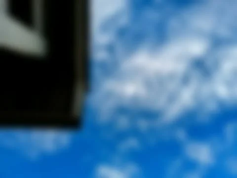 Blue sky with white clouds and a roof Stock Photos