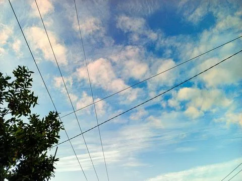 Blue Sky with White Clouds and Power Lines in Outdoor Environment Stock Photos