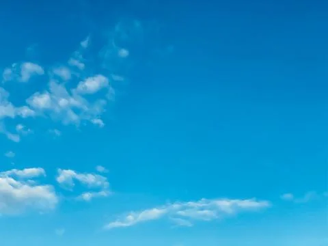 Blue sky with white clouds background. Clear sunny day Stock Photos