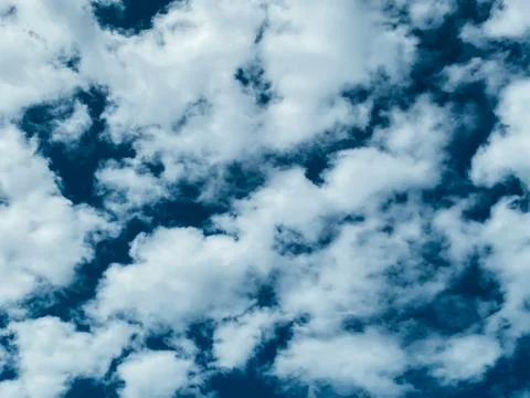 Blue sky with white clouds background. Clear sunny day Stock Photos