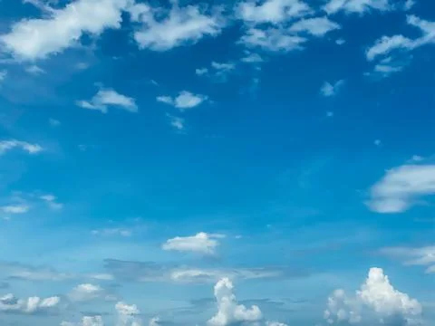 Blue sky with white clouds background. Clear sunny day Stock Photos
