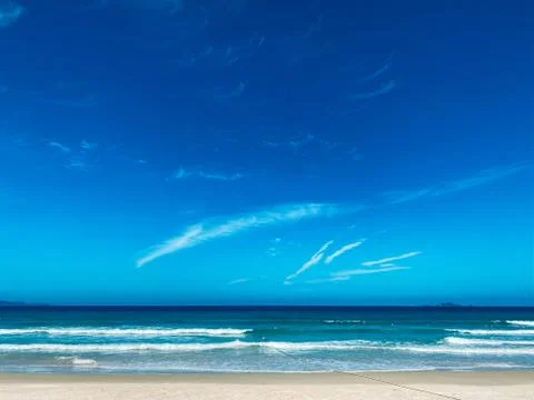 Blue sky with white clouds background. Clear sunny day Stock Photos