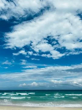 Blue sky with white clouds background. Clear sunny day Stock Photos