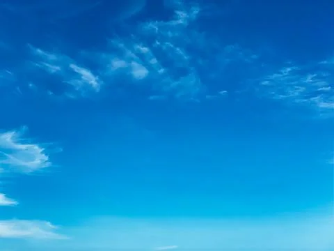 Blue sky with white clouds background. Clear sunny day Stock Photos