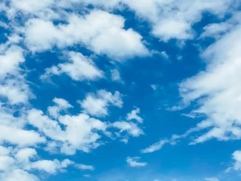 Blue sky with white clouds background. Clear sunny day Stock Photos
