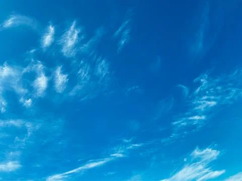 Blue sky with white clouds background. Clear sunny day Stock Photos