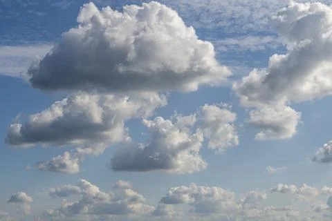 Blue sky with white clouds as a background photo. Stock Photos