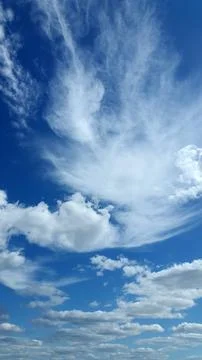 Blue sky with white clouds. Background for postcard or poster Stock Photos