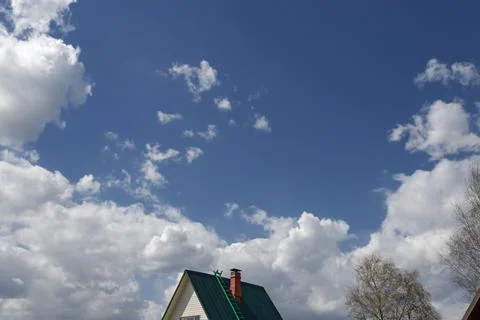 Blue sky with white clouds backlit by sunlight Stock Photos