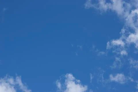 Blue sky with white clouds. Beautiful spring blue sky. White clouds against t Stock Photos