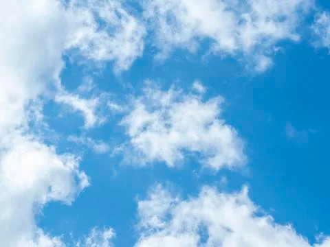 Blue sky with white clouds close-up. Texture, template Stock Photos