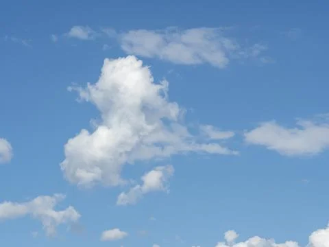 Blue sky with white clouds close-up. Texture, template Stock Photos
