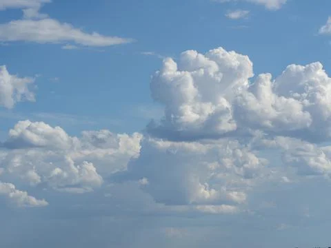 Blue sky with white clouds close-up. Texture, template Stock Photos