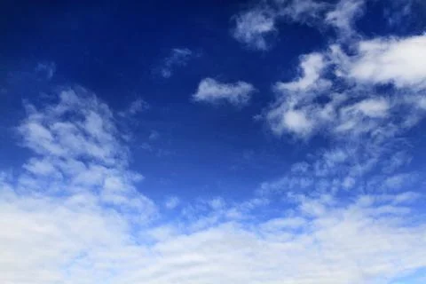 Blue sky with white clouds with copy space on right. Stock Photos