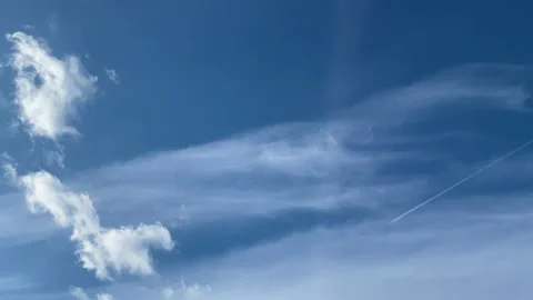 Blue sky with white clouds, a flying plane Stock Footage 151234614