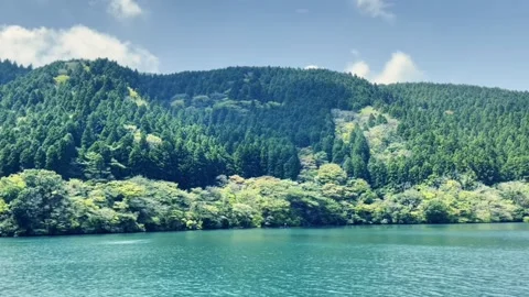 Blue sky, white clouds, green lake water - Lake Ashi Stock Footage 310820984