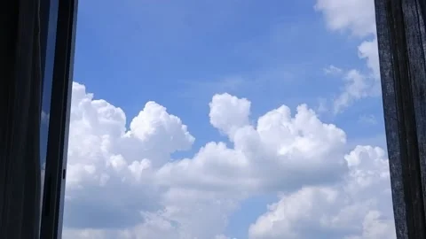 Blue sky with white clouds, looking from the glass window with curtains Stock Footage 131437839