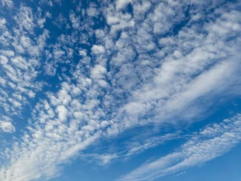 A blue sky with white clouds in the middle of it Stock Photos