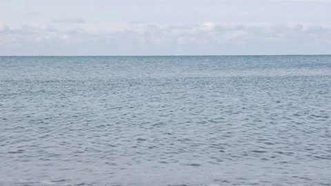 Blue sky with white clouds moving. Sea in light of day. Small waves on sea Stock Footage 149102070