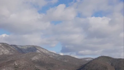 Blue sky white clouds over snow mountains. Puffy fluffy white clouds. Cumulus Stock Footage 150575536
