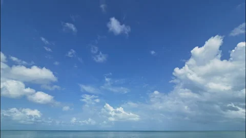 Blue sky with white clouds over the sea, time lapse Stock Footage 331281824