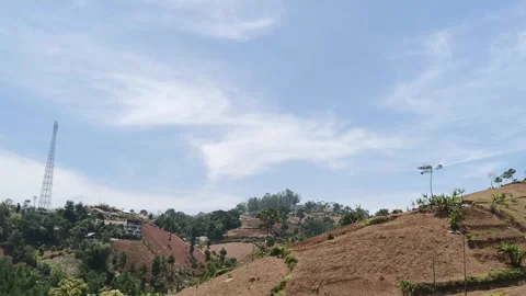 Blue sky with white clouds over rural hillside landscape Stock Footage 346660159
