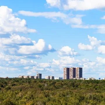 Blue sky with white clouds over urban houses Stock Photos