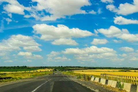 Blue sky with white clouds over road 스톡 사진