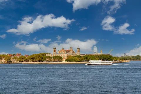 Blue sky with white clouds over Ellis Island and Ellis Island Hospital Stock Photos