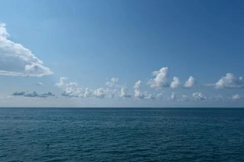 Blue sky with white clouds over the sea. Stock Photos