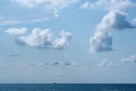Blue sky with white clouds over the sea. Stock Photos