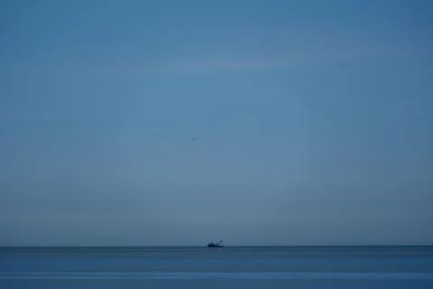 Blue sky with white clouds over calm sea horizon, beautiful seascape Stock Photos