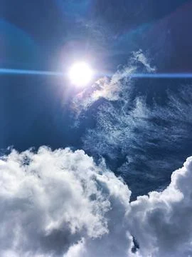 Blue sky with white clouds. The sky is clear and bright, and the clouds are scat Stock Photos