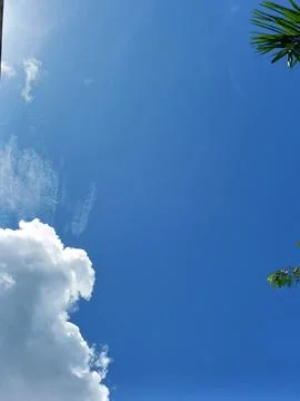 Blue sky with white clouds. The sky is clear and bright, and the clouds are scat Stock Photos