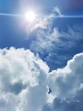 Blue sky with white clouds. The sky is clear and bright, and the clouds are scat Stock Photos