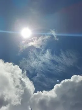 Blue sky with white clouds. The sky is clear and bright, and the clouds are scat Stock Photos