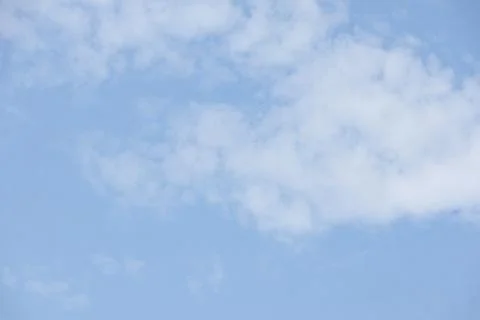 Blue sky with white clouds. The sky is clear and bright, and the clouds  Stock Photos
