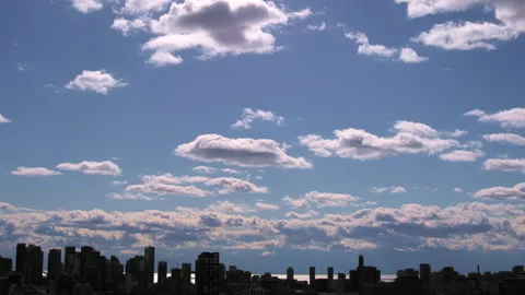 Blue Sky with White Clouds Timelapse over City Skyline GT2211 Stock Footage 163844001