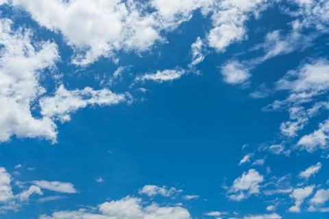 Blue sky with white clouds under sunshine Stock Photos