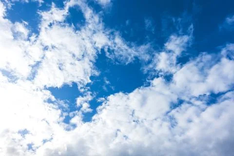 Blue sky with white clouds under sunshine Stock Photos