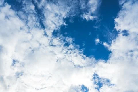 Blue sky with white clouds under sunshine Stock Photos
