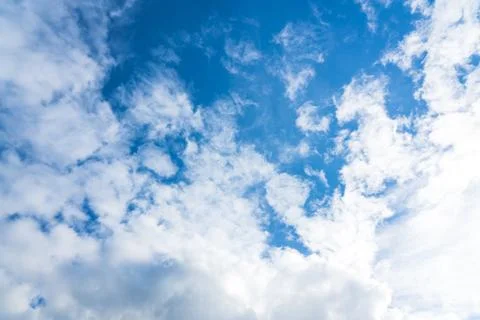 Blue sky with white clouds under sunshine Stock Photos